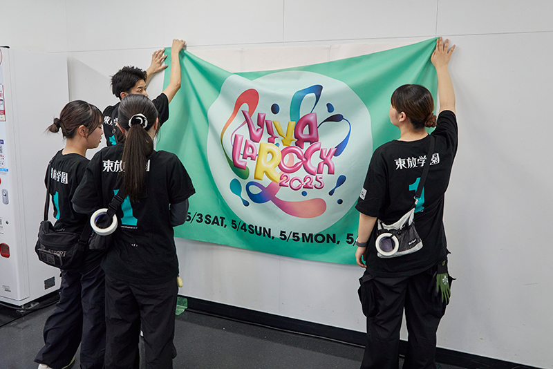 アーティストがサインを書き込む垂れ幕をセッティング